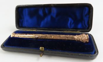 A cased 9ct gold pencil, heavily engraved decorati