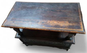 A carved oak Monks bench with hinged seat, 86cms