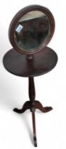 A mahogany pedestal shaving stand with adjustable