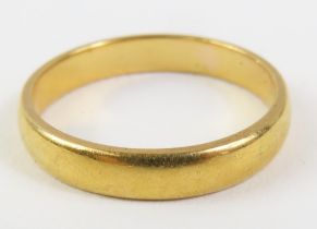 A plain 22ct gold wedding band, finger size K-K1/2