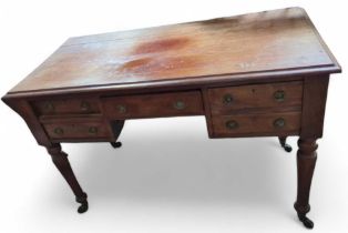 A Victorian red walnut writing table fitted with c