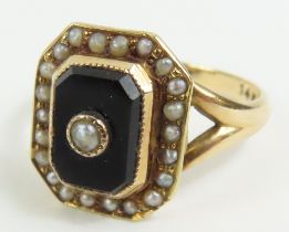An onyx and split pearl ring, marked '14k', finger