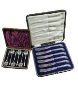 A cased set of six silver tea spoons with figural