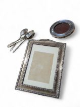 A George V rectangular silver photo frame with oak