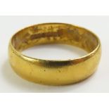 A 22ct gold plain wedding band, finger size L 1/2,