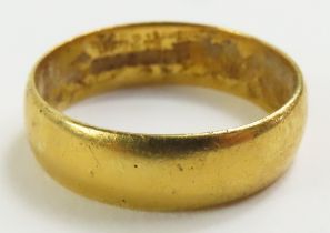 A 22ct gold plain wedding band, finger size L 1/2,