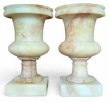 A pair of small marble campana shaped urns, 15.5cm