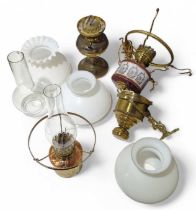 Three hanging oil lamps and a brass oil lamp with