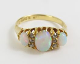 An early 20th century 18ct gold opal and diamond r