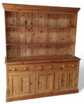 A modern pine kitchen dresser with open shelves ab