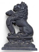 A cast iron door stop in the form of a lion and sc