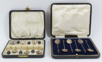 Two cased sets of six silver coffee spoons with co