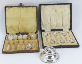 A silver capstan inkwell, together with two sets o