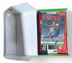 A quantity of Manchester United football programme