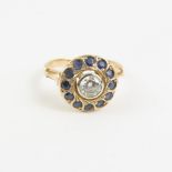 A sapphire and diamond cluster ring, the round dia