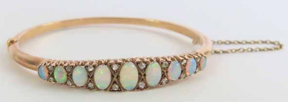 A Victorian opal and diamond hinged bangle, the ni