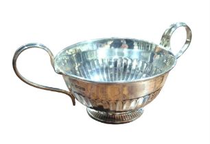 A two handled footed bowl, the body part gadrooned