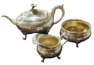 A German silver three-piece tea set, comprising a teapot, milk jug and sugar bowl,