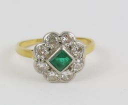 An early 20th century emerald and old cut diamond cluster