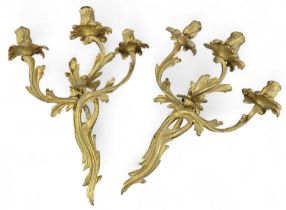 A pair of Rococo style gilt brass three branch wal