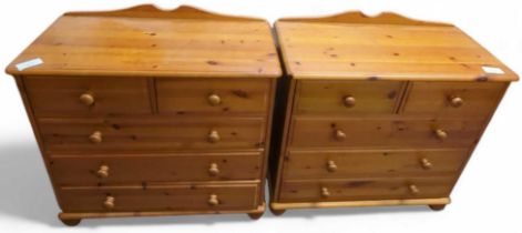 A pair of orange pine chests of two short and thre
