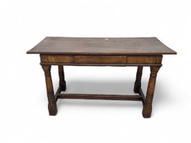 An oak sidetable of refectory style, fitted with a