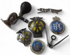 Two AA car badges; an RAC badge; A galloping fox d