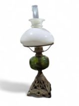 A Victorian oil lamp with white glass shade, green