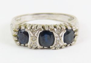 An 18ct white gold sapphire and diamond carved hea
