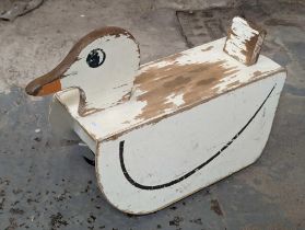 A vintage painted wooden duck toy, with four later