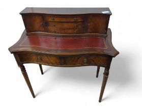 A reproduction mahogany ladies desk, with inset re