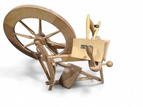 A spinning wheel and a pair of wool carders