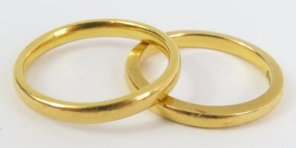 A 22ct gold wedding band, finger size J 1/2; and a