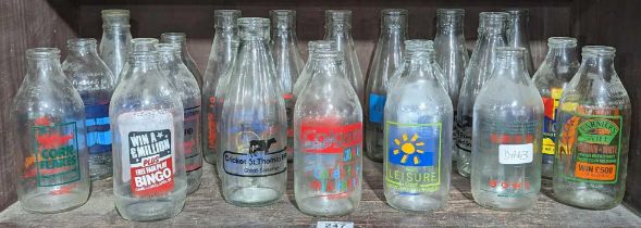 A collection of milk bottles with colourful advert