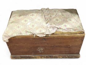 A stained pine blanket box with padded upholstered