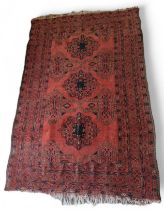 A 20th century wool rug, the three central medalli