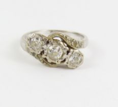 A diamond three stone ring, the old cut stones on
