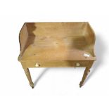 A Victorian pine washstand with low raised back an