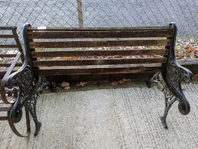 A pair of black painted metal bench ends, with par