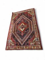 A Middle Eastern wool rug with colourful geometric