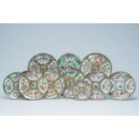 Eleven Chinese Canton famille rose plates with palace scenes and birds and butterflies between bloss