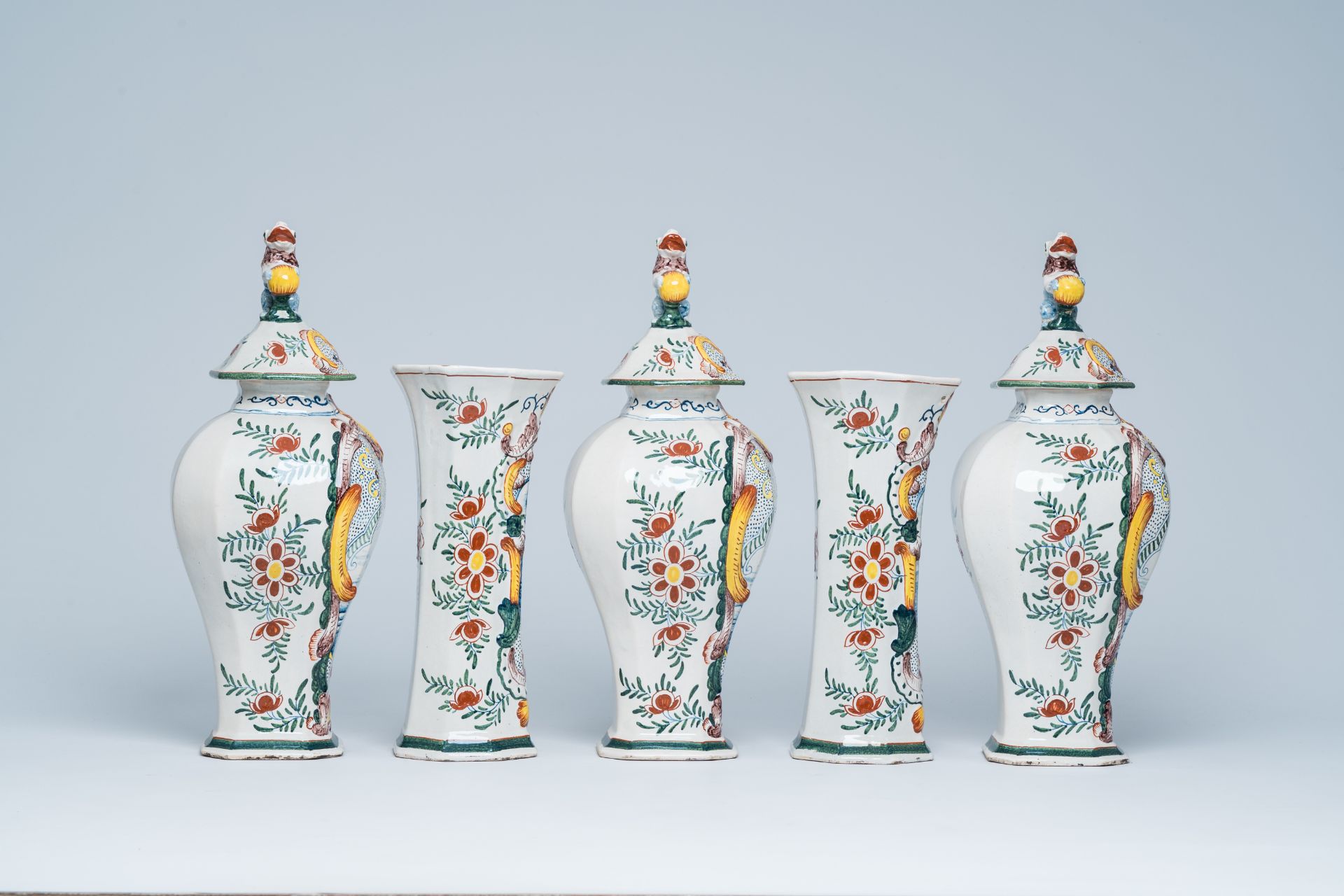 A Dutch Delft polychrome five-piece vase garniture with animated scenes, 19th C. - Image 4 of 7