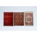 Three oriental rugs with floral design and geometric patterns, wool on cotton, 20th C.