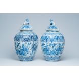 A pair of large Dutch Delft blue and white covered vases, 19th C.