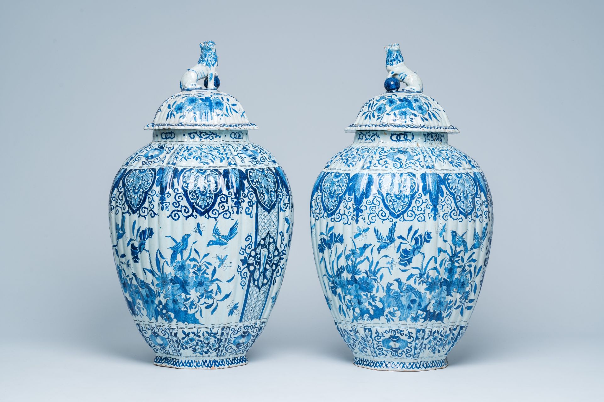 A pair of large Dutch Delft blue and white covered vases, 19th C.