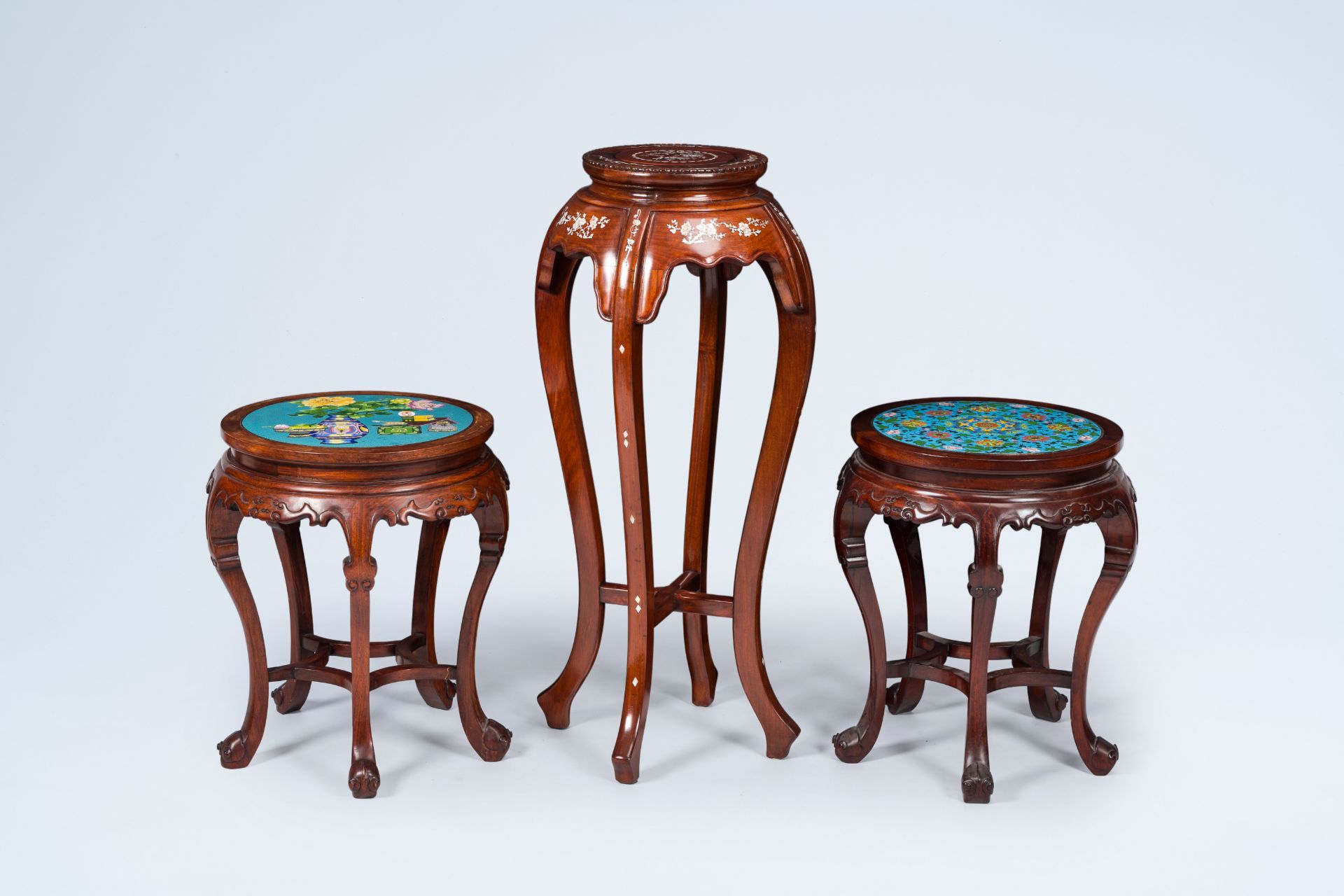 Three Chinese wood stands, one of which inlaid with mother-of-pearl and two with a cloisonne top, 20