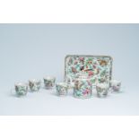 A Chinese Canton famille rose eight-part tea set with birds and butterflies among blossoming branche