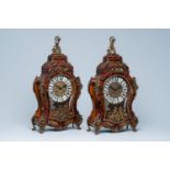 A pair of German Boulle style cartel clocks with faux tortoiseshell, 20th C.