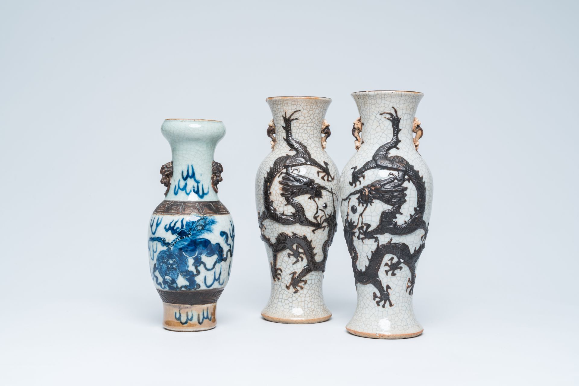 A pair of Chinese Nanking crackle glazed relief decorated 'dragon' vases and a blue and white 'Buddh