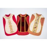 Three various Gothic Revival silk and velor chasubles with embroidered and crocheted floral decor, 1